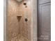 Tile surround shower with rock floor and built in shelf at 10016 Morgan Mill Rd, Monroe, NC 28110