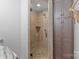 Tile surround shower with rock floor and glass door at 10016 Morgan Mill Rd, Monroe, NC 28110