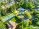 An aerial view showcases community amenities including a pool, tennis, and basketball courts at 10024 Hazelview Dr, Charlotte, NC 28277
