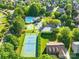 A beautiful community aerial view with a swimming pool, tennis courts, and abundant green spaces at 10024 Hazelview Dr, Charlotte, NC 28277