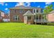 A spacious backyard with a manicured lawn and a cozy screened-in porch with a view at 10024 Hazelview Dr, Charlotte, NC 28277