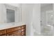The bathroom has a wooden vanity, modern fixtures and a white sink at 10024 Hazelview Dr, Charlotte, NC 28277