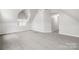 This attic bedroom features carpet flooring, white walls, and natural light from the window at 10024 Hazelview Dr, Charlotte, NC 28277
