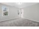 This bedroom features two windows letting in natural light and carpet flooring at 10024 Hazelview Dr, Charlotte, NC 28277