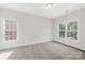 This spacious carpeted bedroom has plenty of natural light from the two windows at 10024 Hazelview Dr, Charlotte, NC 28277
