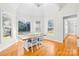 Bright dining room with hardwood floors, large windows, and stylish light fixture perfect for Gathering gatherings at 10024 Hazelview Dr, Charlotte, NC 28277