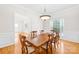 Formal dining room featuring hardwood floors, wainscoting, and elegant lighting at 10024 Hazelview Dr, Charlotte, NC 28277