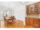 Elegant dining room with natural lighting, hardwood flooring, and custom cabinet details at 10024 Hazelview Dr, Charlotte, NC 28277