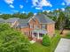 Stately two-story brick home with mature landscaping and a welcoming front porch at 10024 Hazelview Dr, Charlotte, NC 28277