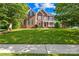 Charming brick home with a covered front porch and lush green lawn at 10024 Hazelview Dr, Charlotte, NC 28277