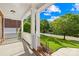 Inviting front porch with white columns, perfect for enjoying the neighborhood views at 10024 Hazelview Dr, Charlotte, NC 28277