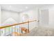 Upstairs hallway featuring a view of the dining room and staircase at 10024 Hazelview Dr, Charlotte, NC 28277