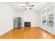 Inviting living room with fireplace, stainless fridge and hardwood floors, filled with natural light and ample space at 10024 Hazelview Dr, Charlotte, NC 28277