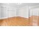 Spacious living room boasting hardwood floors, elegant built-in shelves, and an open layout for versatile living at 10024 Hazelview Dr, Charlotte, NC 28277