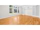 Bright living room features hardwood floors, large windows, and custom built-in shelves for a stylish and functional space at 10024 Hazelview Dr, Charlotte, NC 28277
