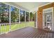 A screened-in porch offers outdoor seating, wood floors and beautiful views of the yard at 10024 Hazelview Dr, Charlotte, NC 28277