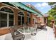 Expansive outdoor deck with brick accents, dining tables, and a view of the landscaped yard at 10317 Clubhouse View Ln, Mint Hill, NC 28227