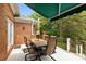 Inviting outdoor deck with dining area, comfortable seating, and retractable awning for shade at 10317 Clubhouse View Ln, Mint Hill, NC 28227
