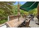 Spacious deck featuring dining table with a tiled top and an awning for shade at 10317 Clubhouse View Ln, Mint Hill, NC 28227