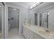 Bathroom featuring double sinks, white cabinetry, tile flooring, and a mirror at 10317 Clubhouse View Ln, Mint Hill, NC 28227