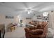This bonus room features a ceiling fan, exercise equipment, shelving, and a comfortable sitting area at 10317 Clubhouse View Ln, Mint Hill, NC 28227