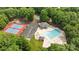 A beautiful community pool and tennis courts surrounded by lush trees, ideal for Gathering fun and recreation at 10317 Clubhouse View Ln, Mint Hill, NC 28227