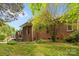This brick home boasts a well-maintained lawn and inviting outdoor space and a cozy patio at 10317 Clubhouse View Ln, Mint Hill, NC 28227