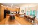 Open kitchen and dining area with wood cabinets, breakfast bar, and large windows providing ample natural light at 10317 Clubhouse View Ln, Mint Hill, NC 28227