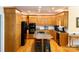 Open kitchen and dining area featuring a center island, wood cabinets, and modern appliances at 10317 Clubhouse View Ln, Mint Hill, NC 28227