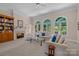 Bright living room with built-in bookshelves, a fireplace, and large windows offering natural light at 10317 Clubhouse View Ln, Mint Hill, NC 28227
