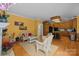 A spacious open-plan living area that connects the kitchen and a sitting area with a fireplace at 10317 Clubhouse View Ln, Mint Hill, NC 28227