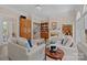A spacious living room with neutral tones, a fireplace, and ample natural light from large windows at 10317 Clubhouse View Ln, Mint Hill, NC 28227
