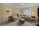 Cozy living room with neutral sofas, an ottoman, and soft, natural light at 10317 Clubhouse View Ln, Mint Hill, NC 28227