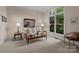 Cozy living room featuring large windows and neutral decor at 10317 Clubhouse View Ln, Mint Hill, NC 28227