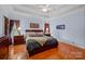 A gorgeous main bedroom featuring a tray ceiling, hardwood floors, and large windows at 10317 Clubhouse View Ln, Mint Hill, NC 28227