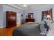Spacious main bedroom featuring tray ceilings, hardwood floors, and large windows with red drapes at 10317 Clubhouse View Ln, Mint Hill, NC 28227