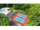Overhead shot of community amenities, including blue and red tennis courts with green trees at 10317 Clubhouse View Ln, Mint Hill, NC 28227