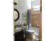 A well-lit bathroom features granite countertops, decorative framed art, tile accents, and neutral tones at 104 Bunker Way # 1001, Mooresville, NC 28117