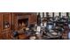 An elegant dining room features a stone fireplace, wood paneling, hardwood floors, and dark leather chairs at 104 Bunker Way # 1001, Mooresville, NC 28117