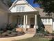 Charming home entrance featuring brick stairs, stone accents, and a covered porch with seating at 104 Bunker Way # 1001, Mooresville, NC 28117