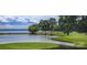 Scenic golf course view with lush green fairways, water features, and a beautiful lakeside backdrop at 104 Bunker Way # 1001, Mooresville, NC 28117