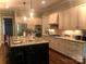 Spacious kitchen featuring granite countertops, stainless steel appliances, and a large center island at 104 Bunker Way # 1001, Mooresville, NC 28117