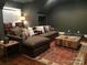 Cozy living room featuring a sectional sofa with multiple pillows, an area rug, and hardwood floors at 104 Bunker Way # 1001, Mooresville, NC 28117