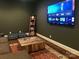 Cozy living room features a mounted TV, a wooden block coffee table, an area rug, and hardwood floors at 104 Bunker Way # 1001, Mooresville, NC 28117