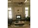 Inviting living room with a fireplace, coffered ceiling, and ample natural light at 104 Bunker Way # 1001, Mooresville, NC 28117