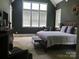 Comfortable bedroom with a large window, vaulted ceiling, and a chair by the window at 104 Bunker Way # 1001, Mooresville, NC 28117