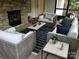 Comfortable screened porch with a stone fireplace, neutral furniture, and natural light at 104 Bunker Way # 1001, Mooresville, NC 28117