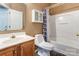 This bathroom has a wood vanity, toilet, shower, and bathtub at 10927 Chrudan Dr, Charlotte, NC 28262
