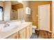 This bathroom has a double sink vanity with wood cabinets and a large mirror at 10927 Chrudan Dr, Charlotte, NC 28262