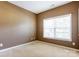 This is a carpeted bedroom with tan walls and a window with blinds at 10927 Chrudan Dr, Charlotte, NC 28262